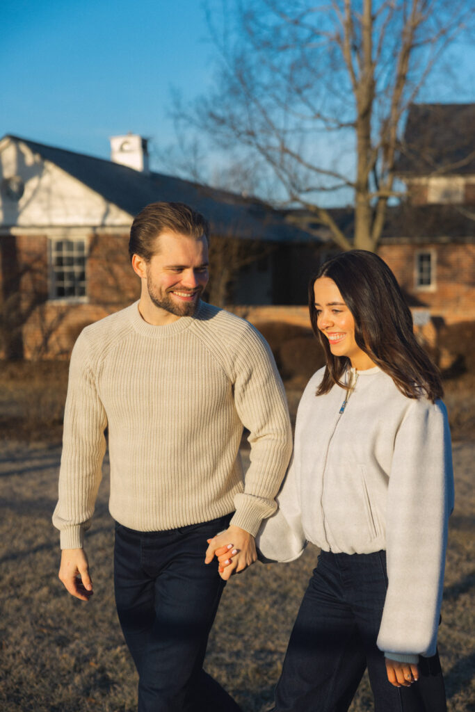 Couple walking side by side in soft morning light at Elawa Farm Lake Forest