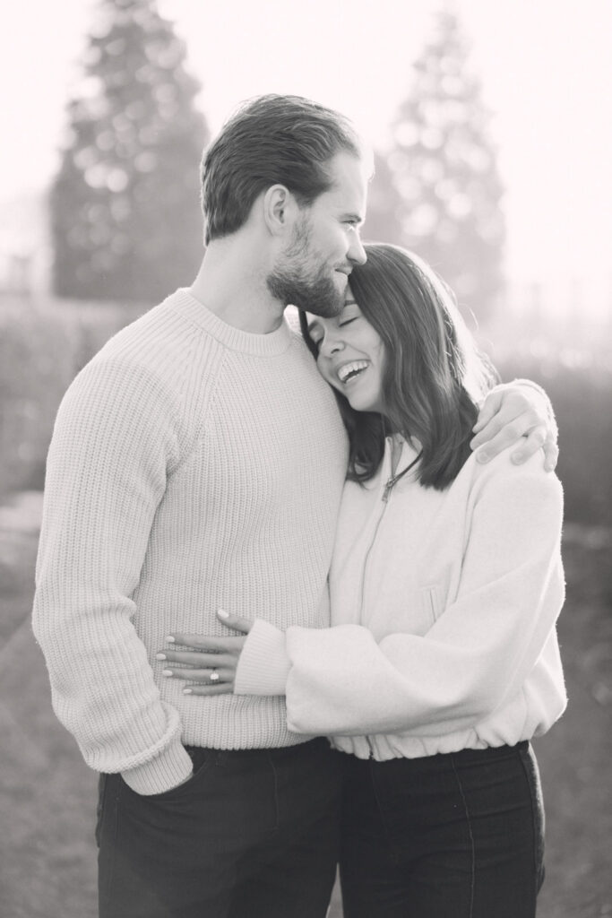 Black and white close up of couple smiling together during engagement session
