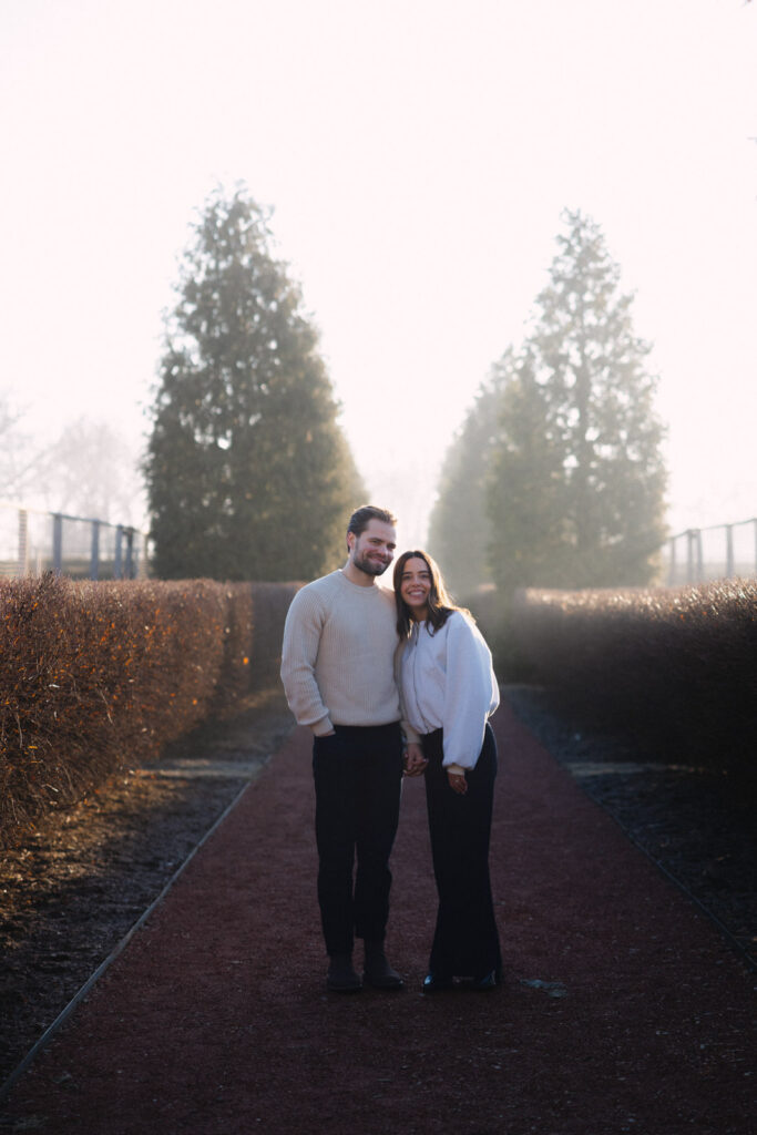 Couple standing together on garden path at Elawa Farm Lake Forest engagement session