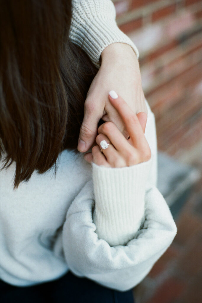Close up of hands holding during engagement session natural light detail captured on film.
