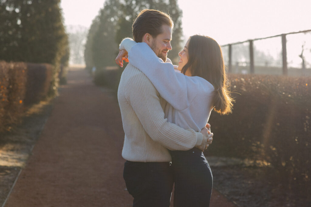 Couple embracing on garden path in soft morning light at Elawa Farm