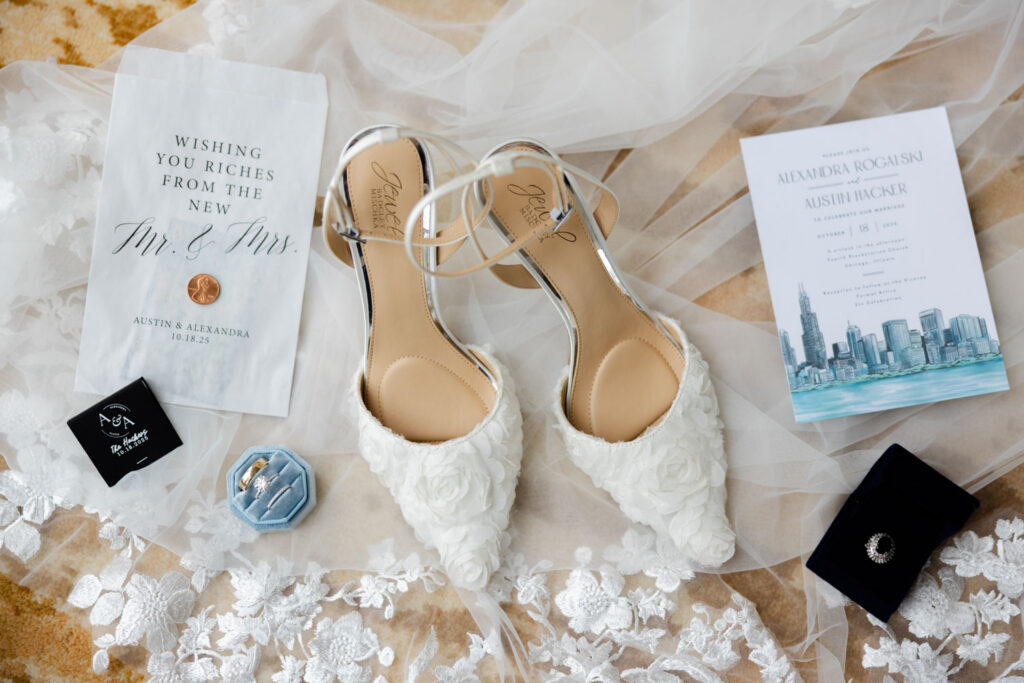 Bridal shoes, invitation suite, and wedding details arranged on a table