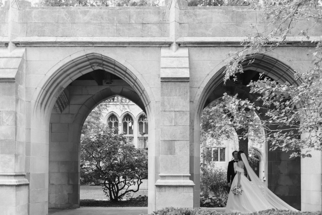 Bride walking through ivy-covered stone arches at Fourth Presbyterian Church