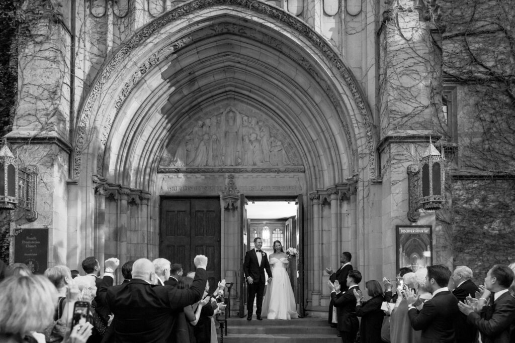Guests celebrating as bride and groom exit Fourth Presbyterian Church