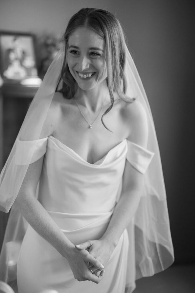 Bride smiling while getting ready on wedding morning