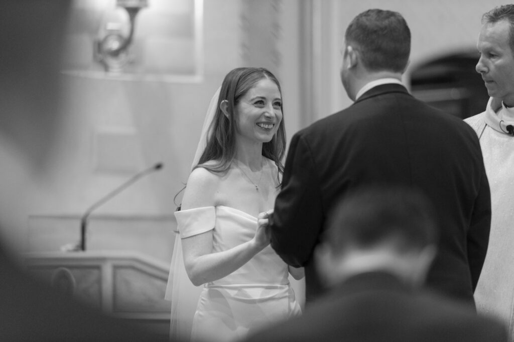 Bride and groom exchanging vows during Catholic wedding ceremony