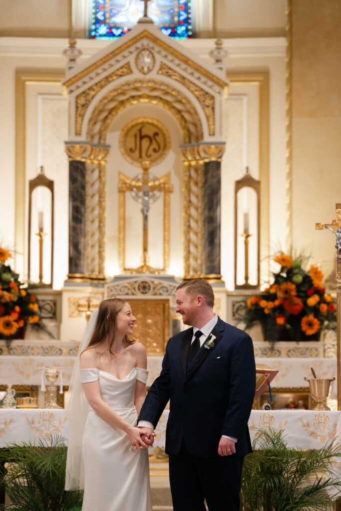 Bride and groom holding hands at the altar after wedding ceremony