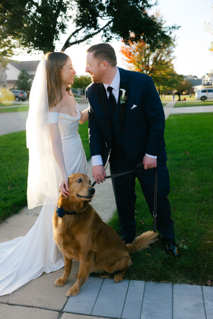 Bride and groom with golden retriever outside church after wedding ceremony