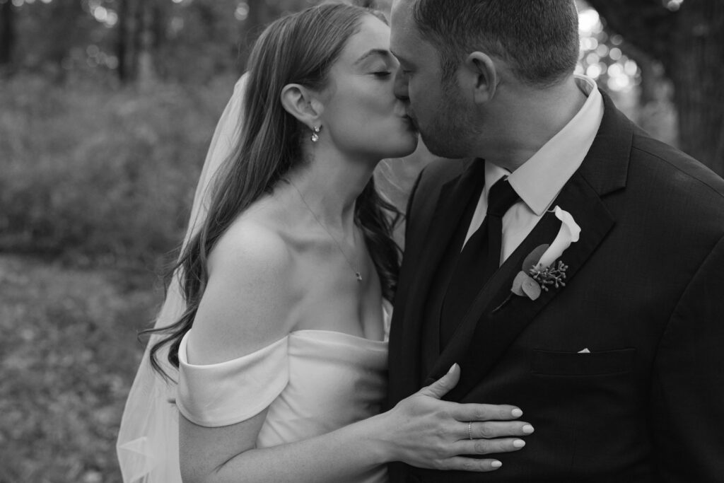 Close portrait of bride and groom kissing during Arboretum wedding portraits