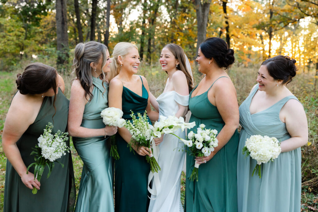 Bridesmaids laughing together during outdoor wedding portraits