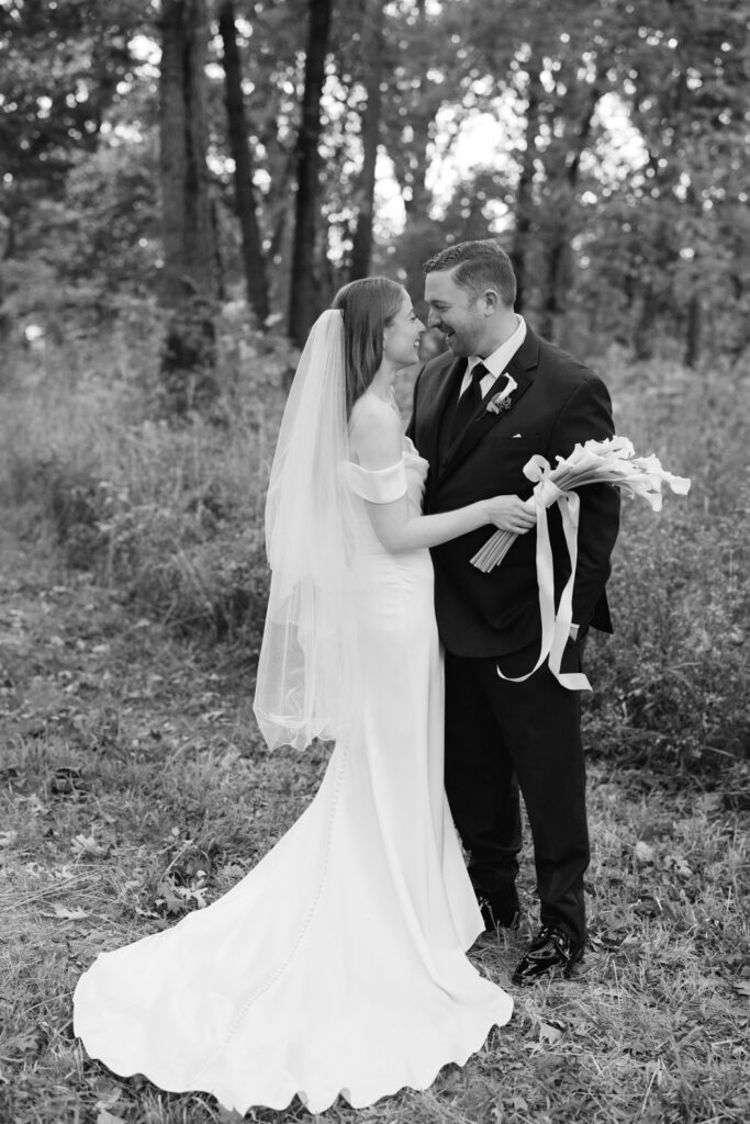 Bride and groom holding bouquet during Arboretum wedding portraits