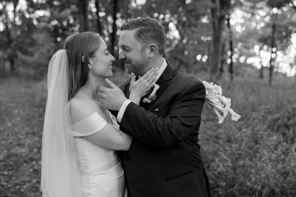 Bride and groom embracing during outdoor fall wedding portraits
