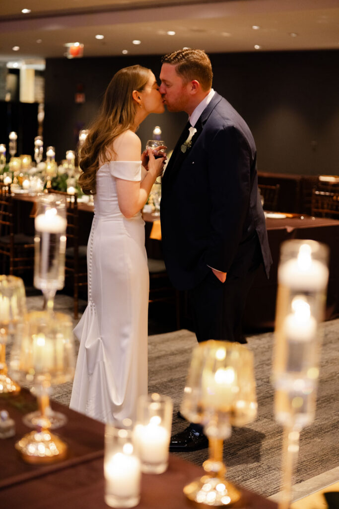 Bride and groom talking together during cocktail hour reception