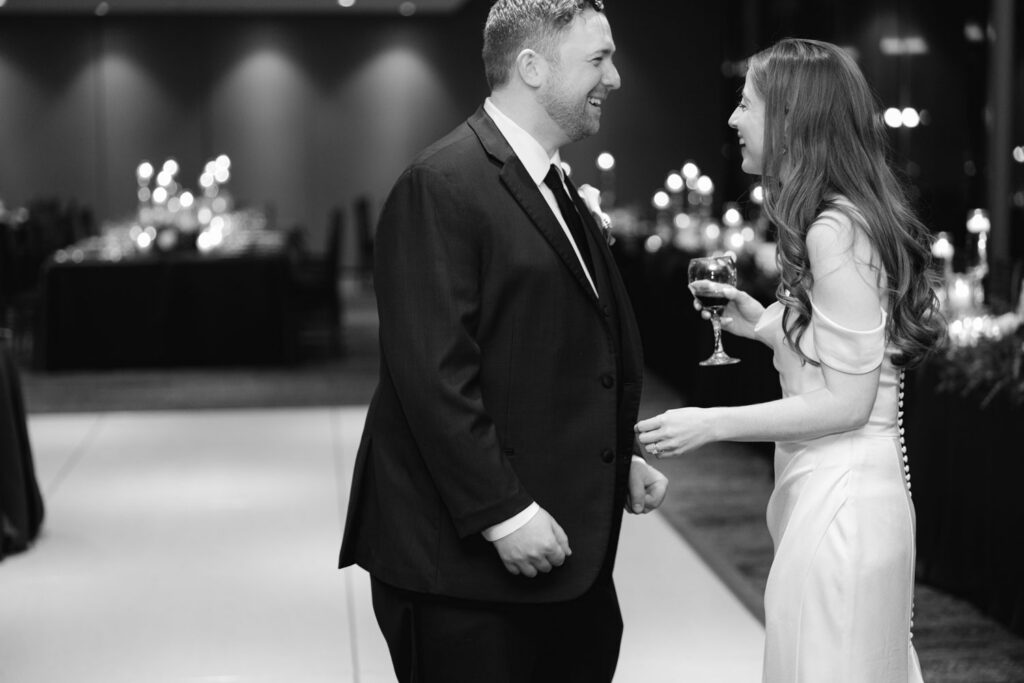 Bride and groom laughing together during reception