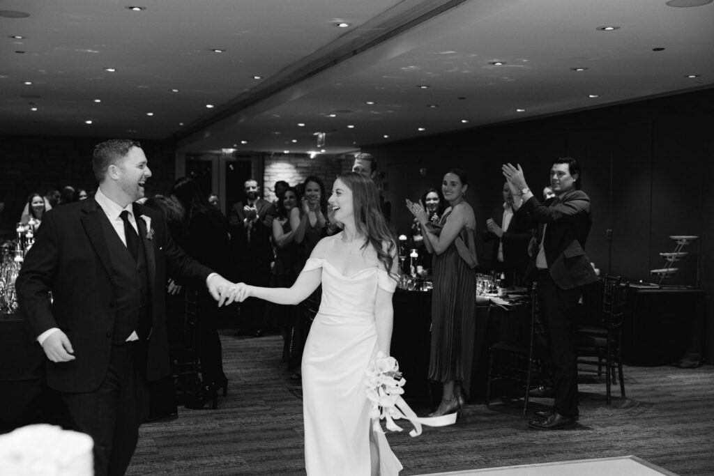 Bride and groom laughing together during reception