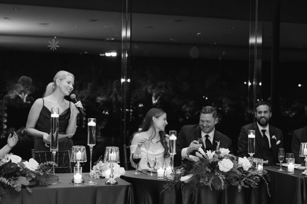 Bride and groom smiling during wedding toasts