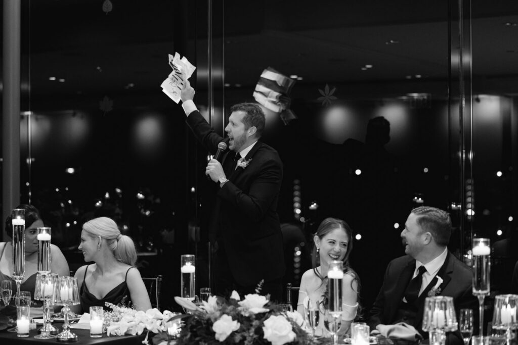 Bride and groom smiling during wedding toasts