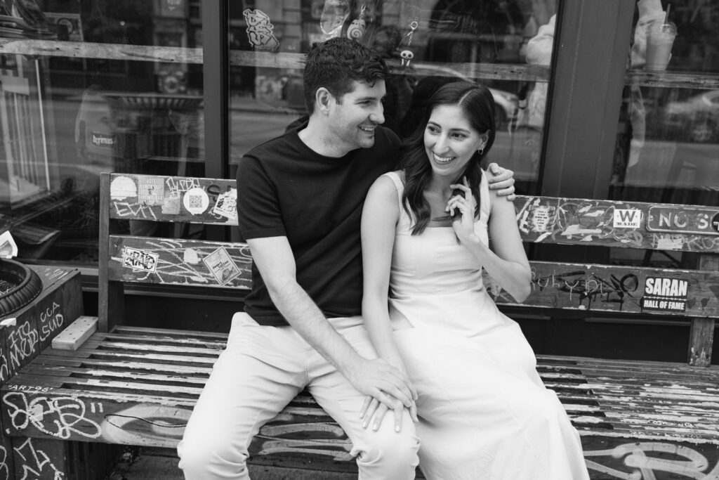 Couple sitting together outside colorful café window in Pilsen Chicago