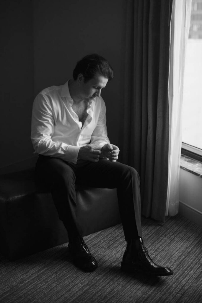 Groom fastening cufflinks in tuxedo prior to summer wedding at RPM Events Chicago.