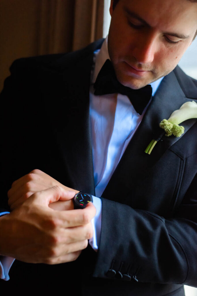 Groom fastening cufflinks in tuxedo prior to summer wedding at RPM Events Chicago.