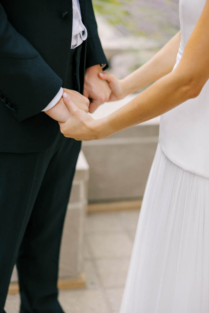 Couple embracing with downtown Chicago skyline in the background on their wedding day.