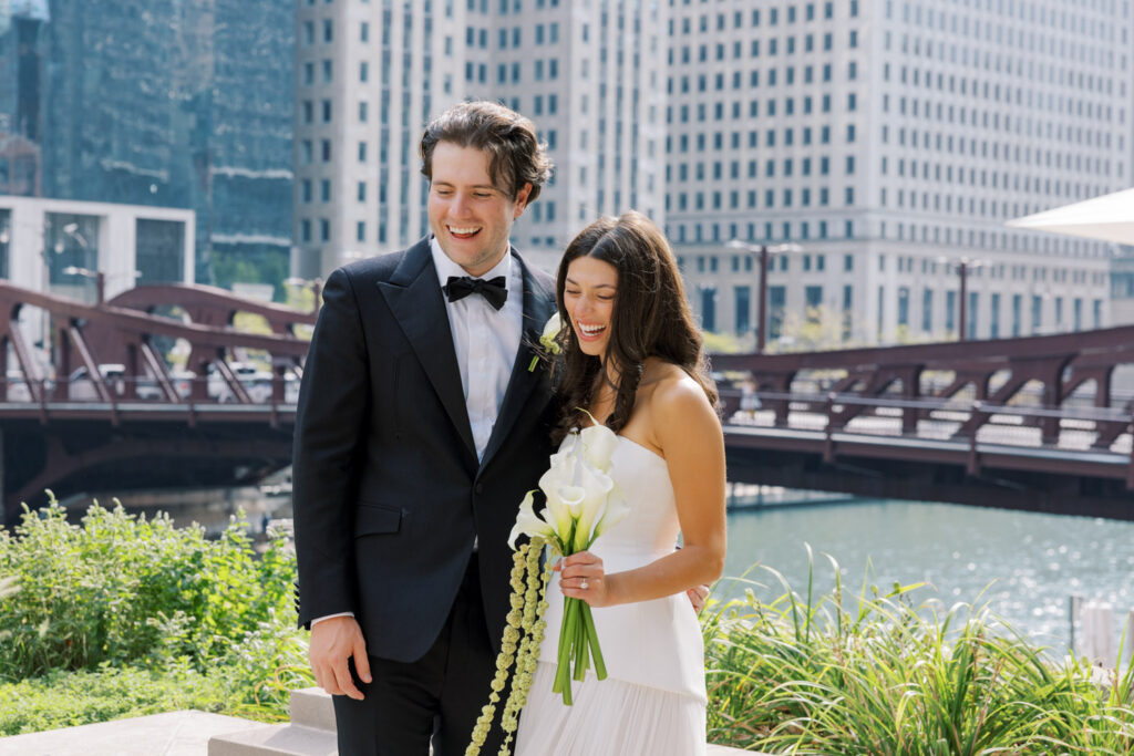 Bride and groom posing along the Chicago Riverwalk before their RPM Events wedding reception.