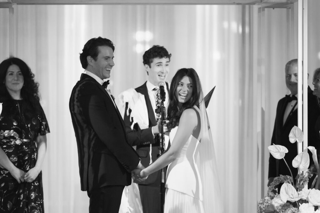 Bride and groom standing beneath a floral chuppah during Jewish wedding at RPM Events Chicago.