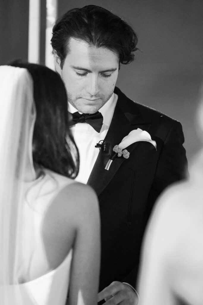Bride and groom standing beneath a floral chuppah during Jewish wedding at RPM Events Chicago.