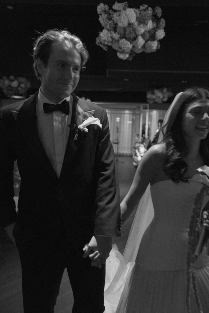 Bride walking down the aisle during modern Chicago wedding ceremony.