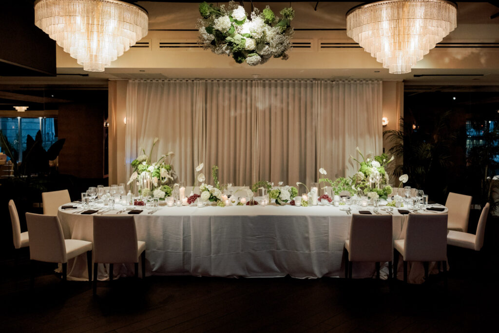 Candlelit reception tables with floral centerpieces during summer wedding at RPM Events in Chicago.