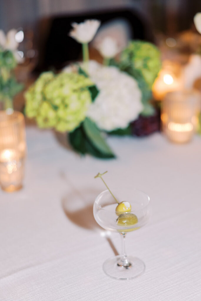 Detail shot of an ice cold martini with an olive