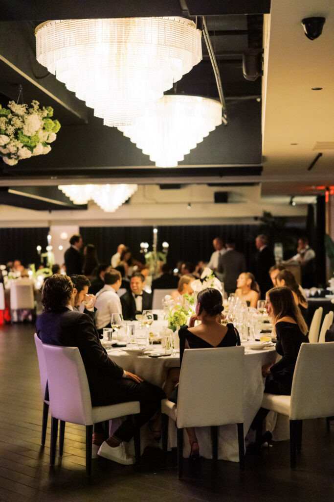 Guests seated at candlelit tables during dinner reception at RPM Events Chicago.