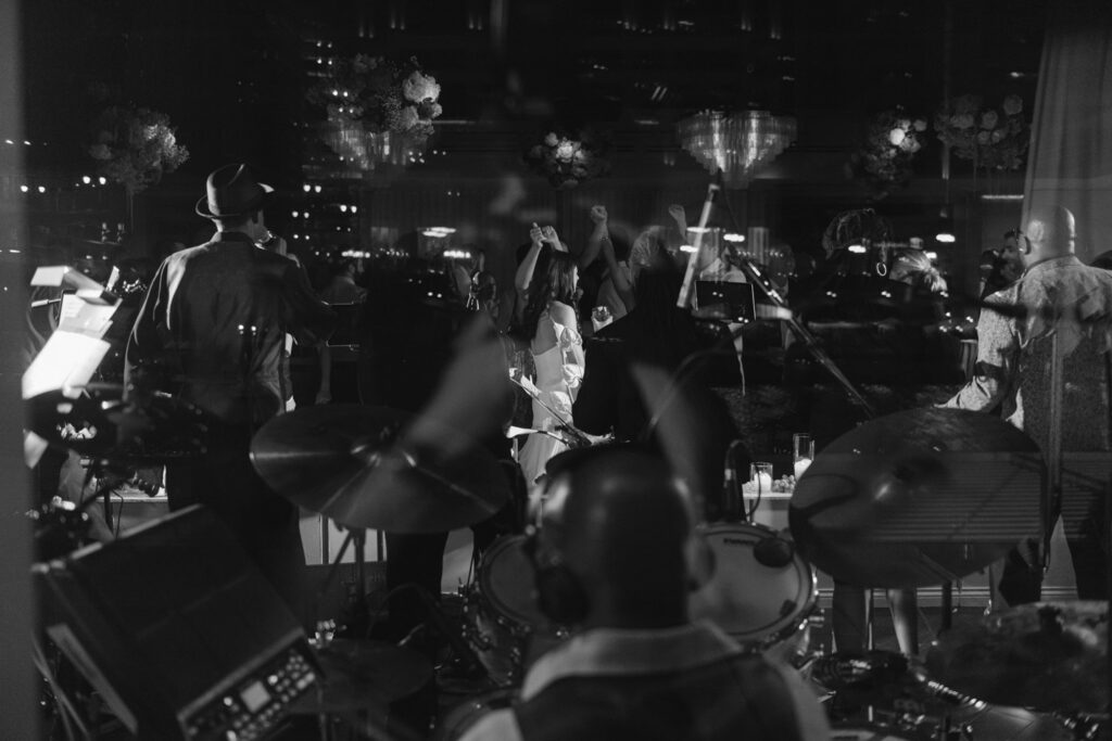 Guests dancing energetically during modern summer wedding reception in Chicago.