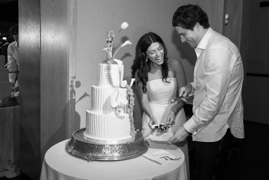 Bride and groom cutting tiered wedding cake during RPM Events reception.