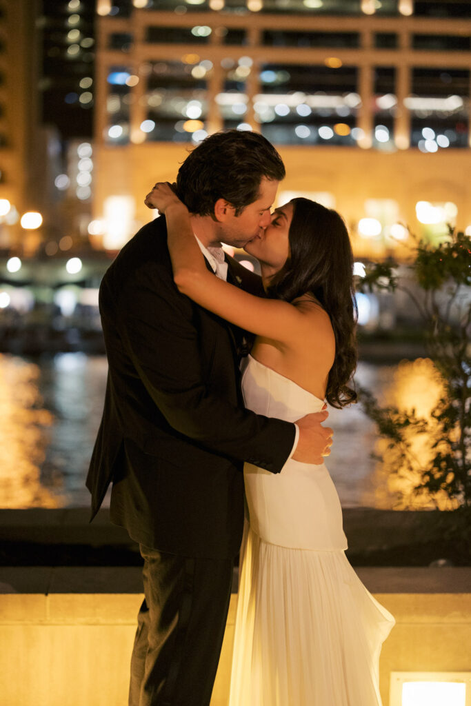 Couple kissing by the Chicago River after their summer RPM Events wedding celebration.