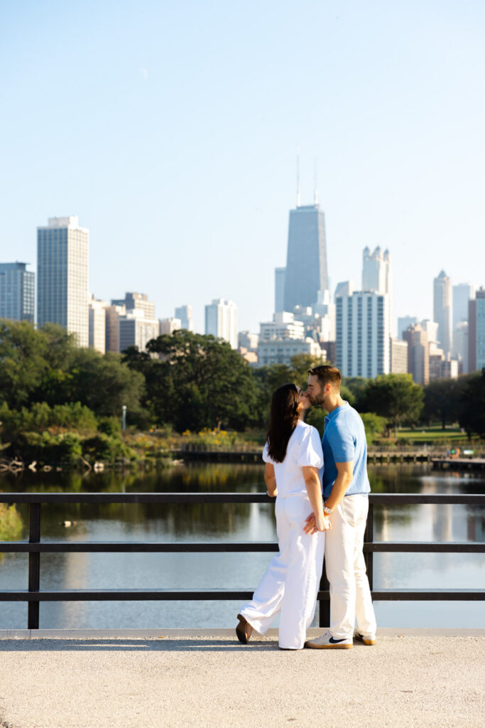Couple standing with Chicago skyline view during Lincoln Park engagement session