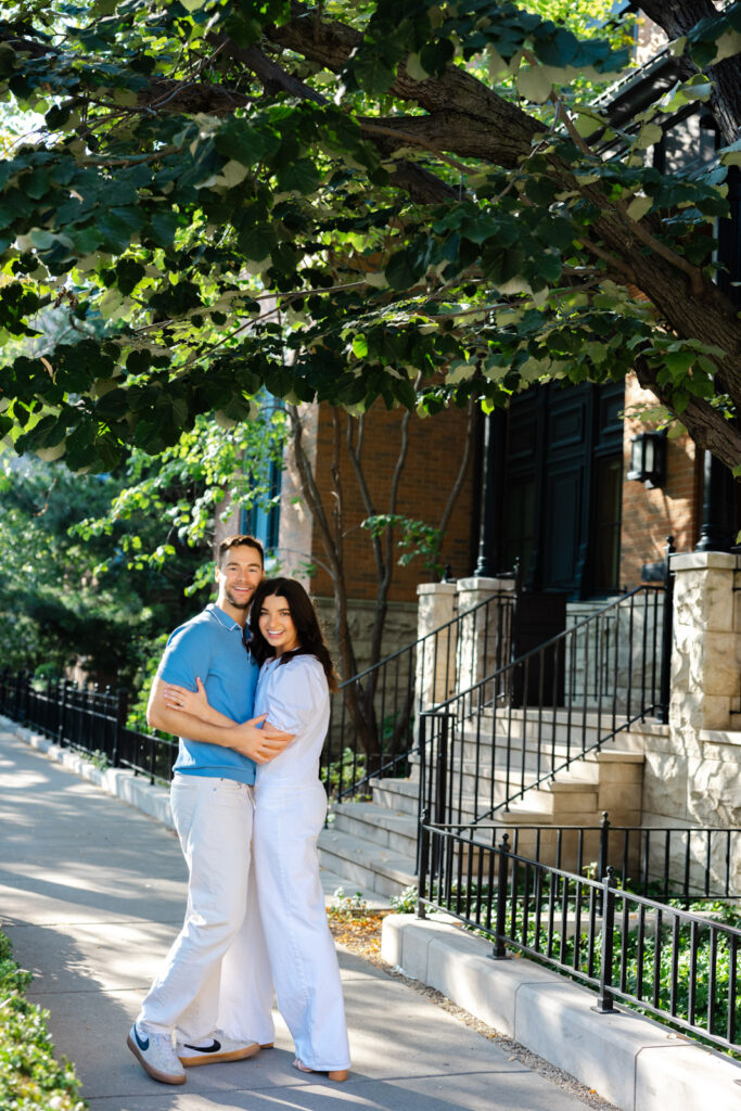 Couple standing together on tree lined sidewalk in Lincoln Park Chicago engagement session