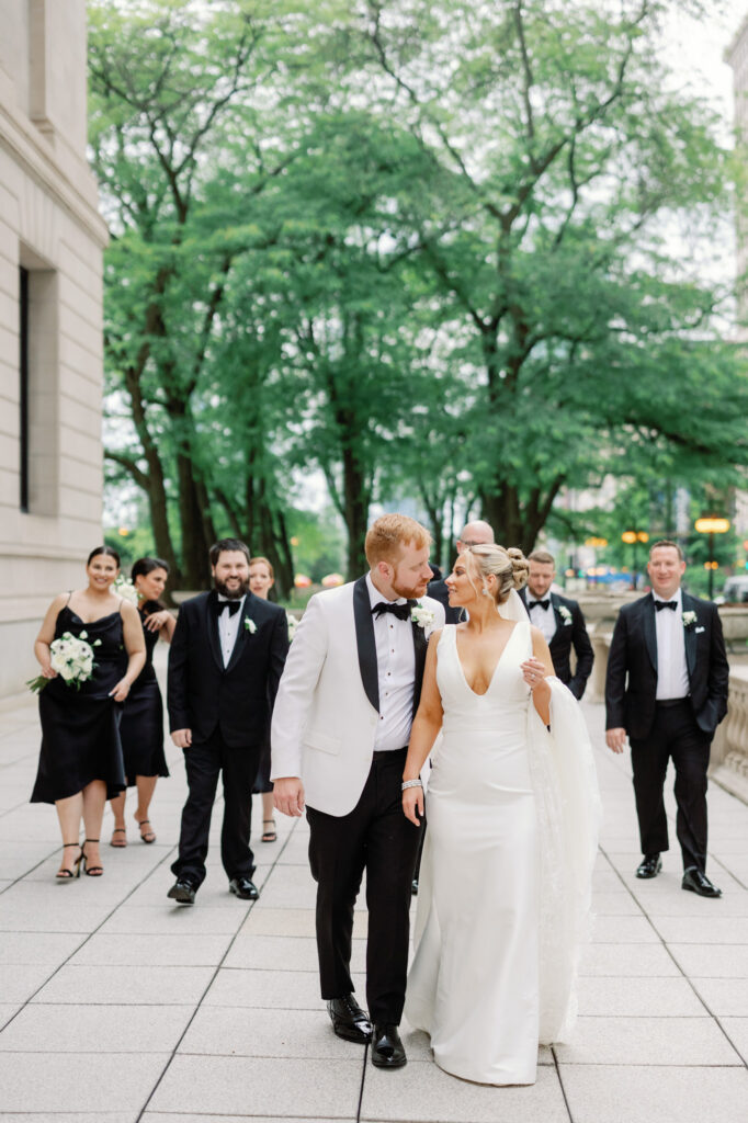 Wedding party walking together through the Art Institute Gardens in Chicago before the ceremony.