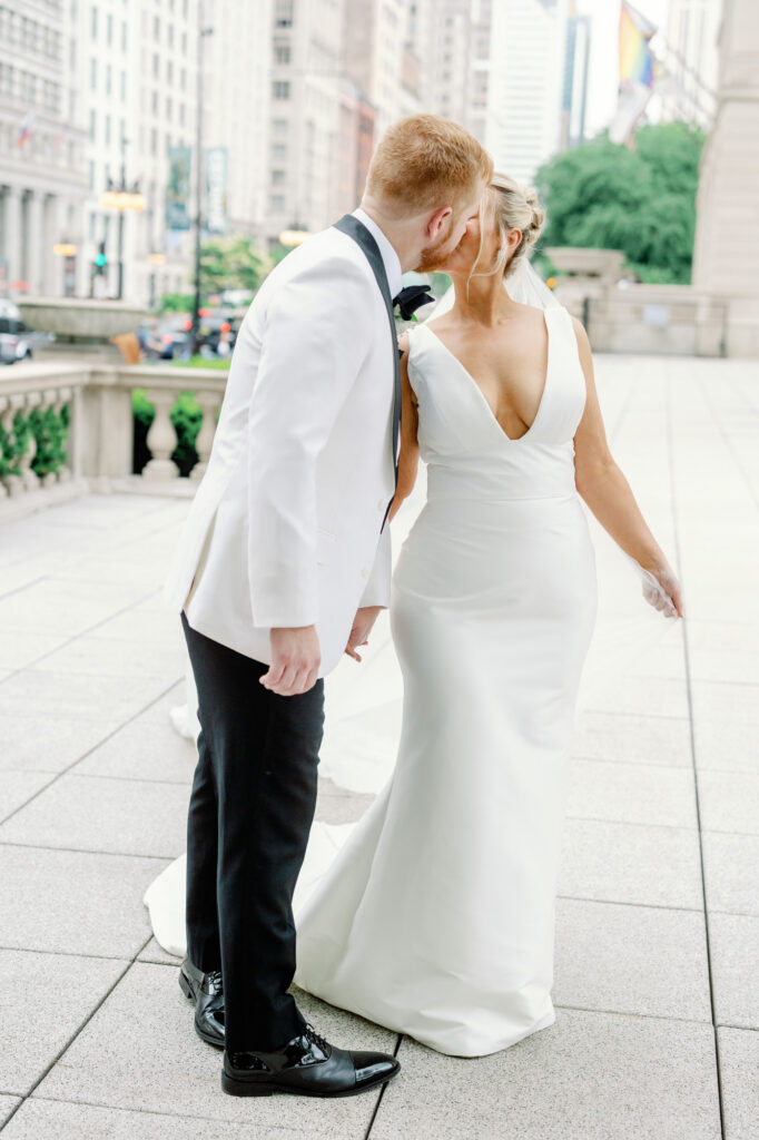 Bride and groom sharing a quiet kiss during Art Institute of Chicago Gardens wedding portraits.
