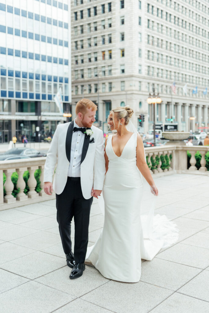 Bride and groom walking together in downtown Chicago near the Art Institute before their ceremony.