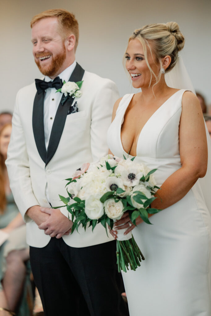 Bride and groom standing together during their ceremony at Mae District wedding in Chicago.