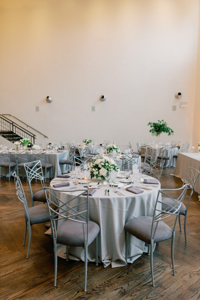 Reception table design with greenery and neutral tones at Mae District wedding in Chicago.