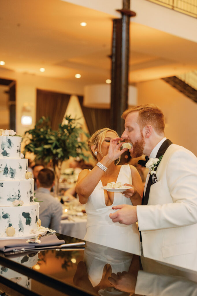 Bride and groom cutting their cake together during their Chicago wedding reception.