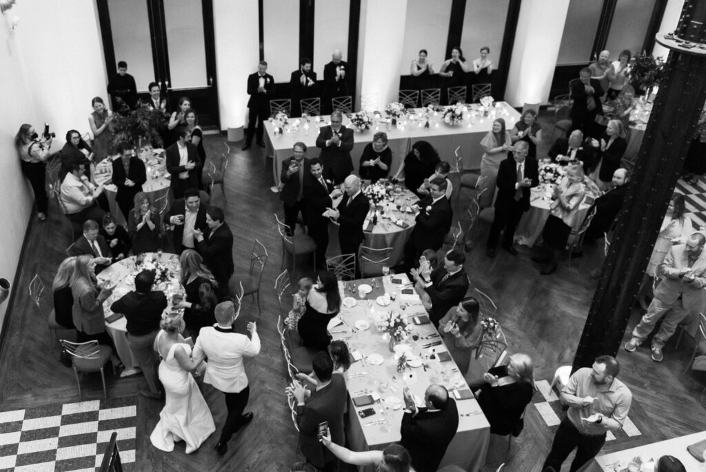 Guests seated and enjoying dinner during the reception at Mae District wedding.