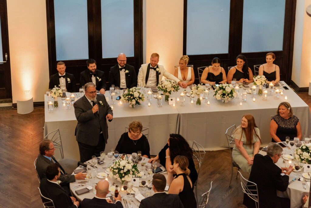 Bride and groom laughing together during dinner at their Mae District wedding.