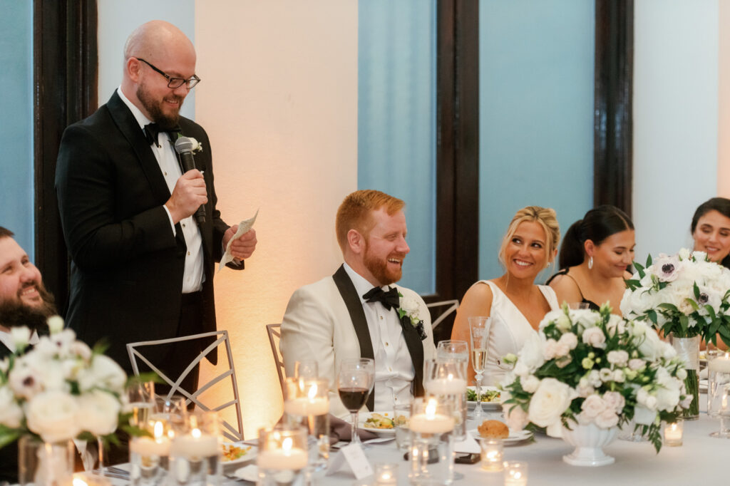 Bride and groom laughing together during dinner at their Mae District wedding.