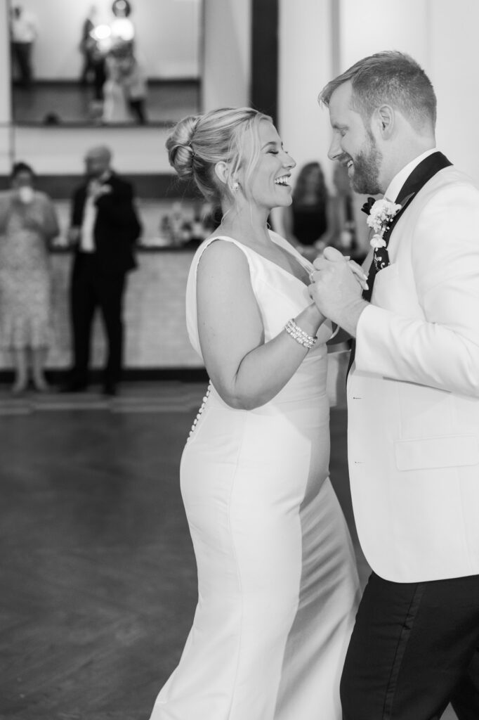 Bride and groom smiling at each other while dancing at their Chicago wedding reception.