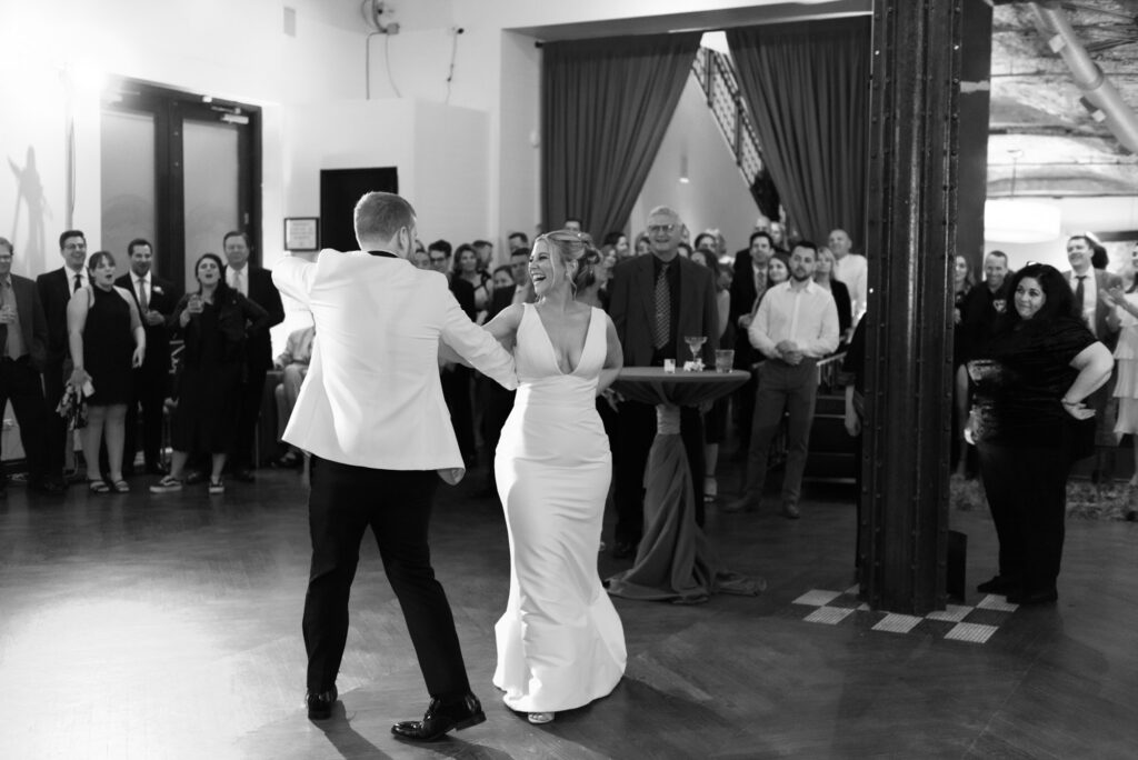 Bride and groom dancing together during their first dance at Mae District wedding in Chicago.