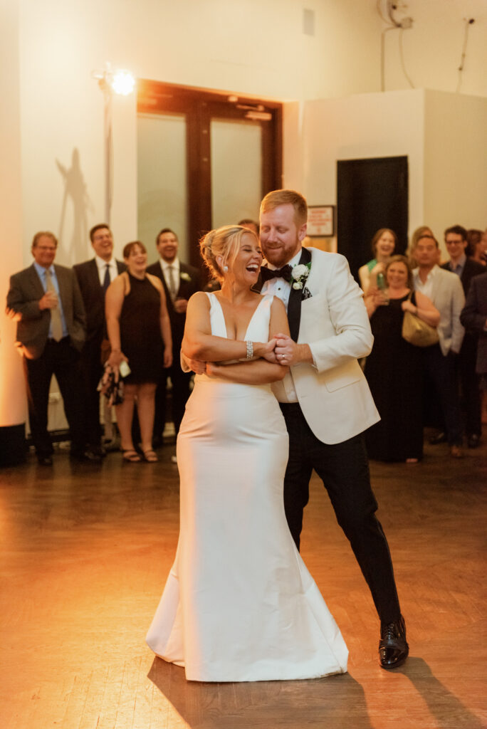 Bride and groom spinning and laughing during their first dance at Mae District.