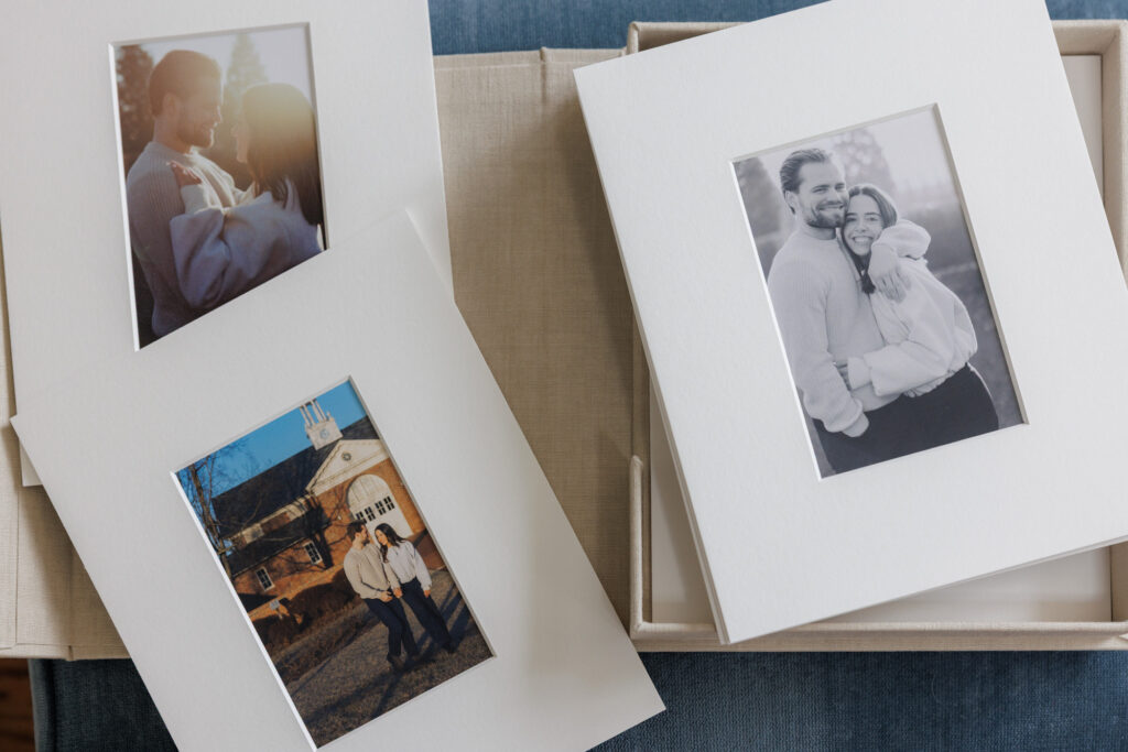 Matted engagement photos displayed outside of a linen box ready for framing